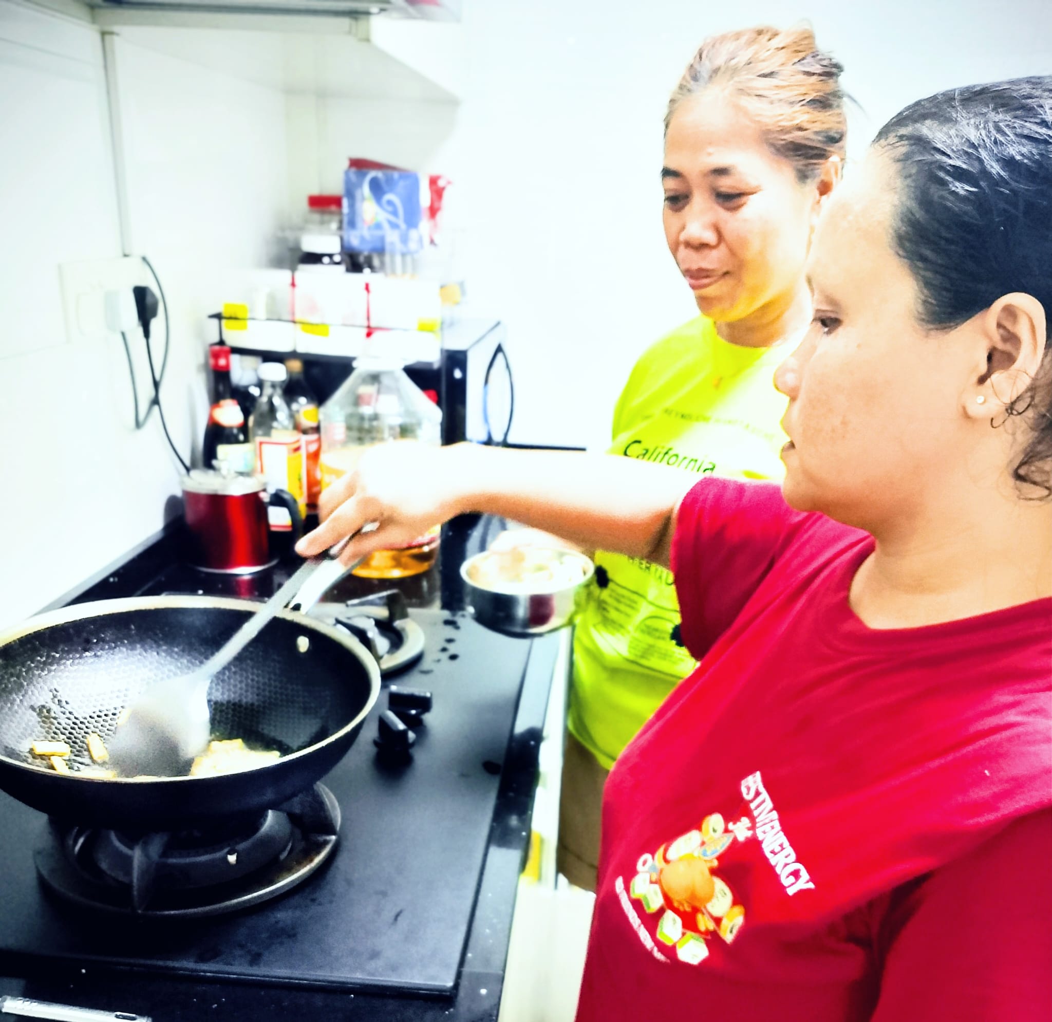Helper cooking training in a Singapore home kitchen